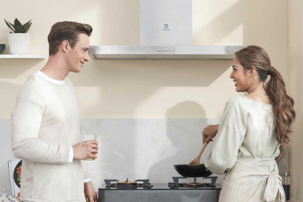 a couple cooking a meal together in the kitchen